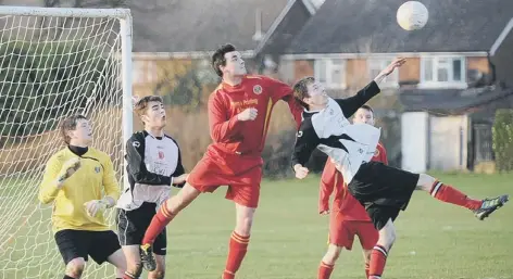  ??  ?? Netherton’s hat- trick hero Ben Cullen ( front) puts pressure on the Oakham defence.