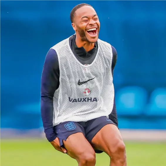  ?? AP ?? Raheem Sterling laughs after being caught in a game of tag as he takes part in England team’s training session at the Spartak Zelenogors­k ground on Tuesday. —