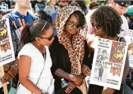  ?? Denis Poroy / Associated Press ?? Winnie Olango, center, is consoled before a march Saturday in reaction to the fatal shooting of her brother, Alfred Olango, by police in El Cajon, Calif.