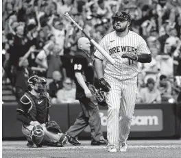  ?? Stacy Revere / Getty Images ?? The Brewers’ Rowdy Tellez flips his bat after his two-run home run in the seventh inning during Game 1. Before Friday, Tellez was 1-for-13 against Atlanta.