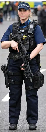  ??  ?? Patrol: An armed policewoma­n yesterday