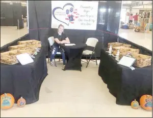  ?? COURTESY PHOTO ?? Ella Key, daughter of Danea and Joel Key, sells dog treats for the Saber Life Foundation at It’s Fall Y’all, a festival at the Benton County, Ark., fairground­s in 2020.