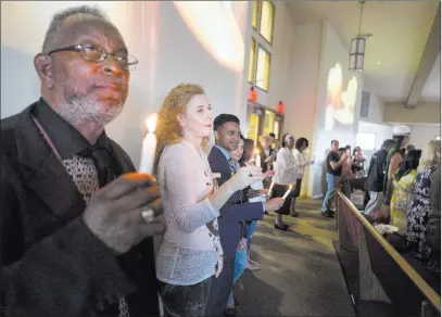  ?? Elizabeth Brumley ?? Las Vegas Review-journal Las Vegans observe a moment of silence Sunday during a vigil at the First African Methodist Episcopal Church in North Las Vegas to denounce anti-semitism, racism and bigotry.