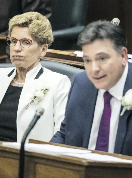  ?? CRAIG ROBERTSON / POSTMEDIA NEWS ?? Ontario Premier Kathleen Wynne and Charles Sousa at the reading of the budget at Queen’s Park.