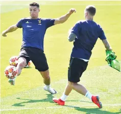  ??  ?? Ronaldo (left) during training at the Juventus Training Centre in Turin. — Reuters photo