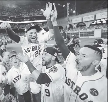  ?? DAVID J. PHILLIP — ASSOCIATED PRESS ?? Jose Altuve is lifted by teammates after the Houston Astros won Game 7 of the American League Championsh­ip Series.