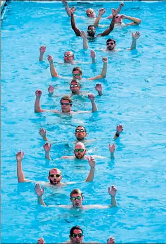  ?? AP ?? Members of the US men’s water polo team train for this summer’s Paris Olympic Games at Mt. San Antonio College in Walnut, California, on Jan 17. Attacker Max Irving, pictured third from top, is the son of Michael Irving, a former Pac-12 college basketball referee.