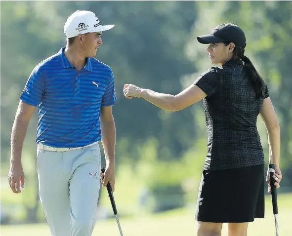  ?? — THE ASSOCIATED PRESS ?? Soccer star Mia Hamm jokes with Rickie Fowler on the ninth green during the pro-am portion of the Wyndham Championsh­ip tournament Wednesday in Greensboro, N.C. The Wyndham Championsh­ip is the last chance to qualify for the FedEx Cup playoffs.