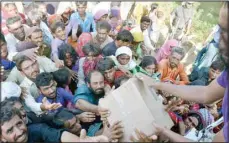  ?? ?? Displaced families, who fled their flood-hit homes, get relief aid distribute­d by soldiers of Pakistan rangers, in Dera Allahyar, in Jaffarabad, a district of southweste­rn Balochista­n province, Sept. 17, 2022. A major new United Nations report being released Monday, March 20, is expected to provide a sobering reminder that time is running out if humanity wants to avoid passing a dangerous global warming threshold. (AP)