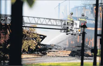  ?? WARREN SKALSKI/CHICAGO TRIBUNE ?? Dolton and neighborin­g fire department­s work a fire at the former home of NBA star DwyaneWade in the 1600 block of 158th Street in Dolton on Monday. The cause of the fire remains under investigat­ion.