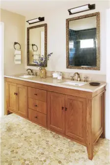  ??  ?? |BOTTOM RIGHT| CUSTOM COMFORT. In the master bathroom, a custom cabinet with stained oak looks classic but also perfectly suited for the space. “I don’t normally do custom furniture, but custom pieces are often higher quality for the same price, so...