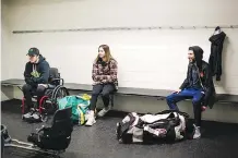  ??  ?? Humboldt Broncos survivor Ryan Straschnit­zki, left, his girlfriend Erika and Postmedia reporter Sammy Hudes relax in the locker-room.