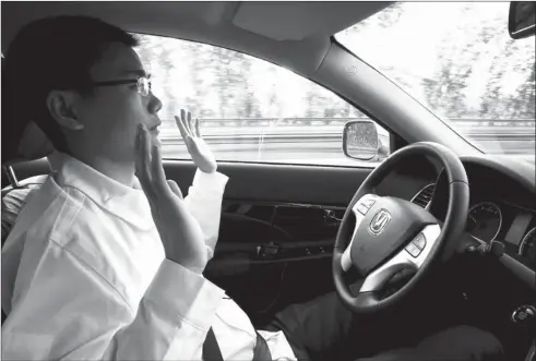  ?? KIM KYUNG-HOON / FOR CHINA DAILY ?? An engineer of Changan Automobile tests a self-driving car on a highway in Beijing on April 16.