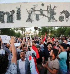  ?? (Khalid Al-Mousily/Reuters) ?? IRAQIS SHOUT SLOGANS during a protest in Baghdad on Monday.