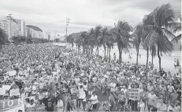  ??  ?? Thousands gather during a protest against corruption at the Copacabana beach in Rio de Janeiro, Brazil. — Reuters photo