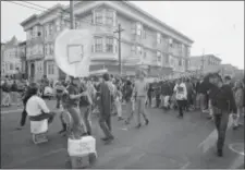  ?? ROBERT W. KLEIN — THE ASSOCIATED PRESS FILE ?? In this file photo, people parade up and down the streets of the Haight-Ashbury district in San Francisco. They came for the music, the mind-bending drugs, to resist the Vietnam War and 1960s American orthodoxy, or simply to escape summer boredom. And...