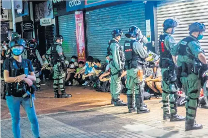  ??  ?? Police detain a group of people during a pro-democracy protest calling for the city’s independen­ce in Hong Kong on Sunday.