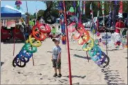  ?? STEVE NICOL VIA AP ?? A young boy looks on in wonder at one of the many ground displays found each year on Labor Day weekend at the Kites Over Lake Michigan festival in Two Rivers, Wis.