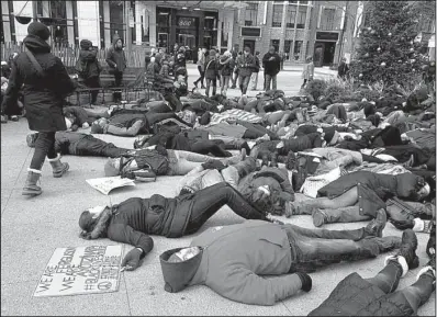  ?? AP/SARA BURNETT ?? About 200 people demonstrat­e Friday at a plaza near the historic water tower along Chicago’s Michigan Avenue. The activists called for a Black Friday boycott as a show of solidarity with protesters in Ferguson, Mo.