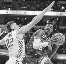  ?? AJ Mast / Associated Press ?? Duke’s RJ Barrett (5) looks to shoot around Kentucky’s Reid Travis in the first half of Tuesday night’s season-opening game at Indianapol­is.