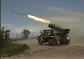  ?? ALEXEI ALEXANDROV — THE ASSOCIATED PRESS FILE ?? A Donetsk People's Republic militia's rocket launcher fires from its position in eastern Ukraine on May 28.