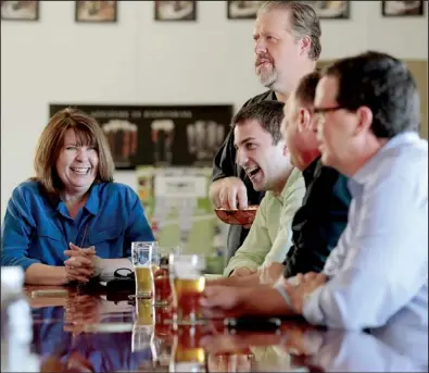  ?? NWA Media/JASON IVESTER ?? Donna Williams (from left), Bryan Gott and Scott Compton, all of Fayettevil­le, Matt Baker of Springdale and Scott Caldwell of Rogers sit at the bar while trying brews Wednesday at Core Brewery in Springdale. Core is one of seven breweries that are part...