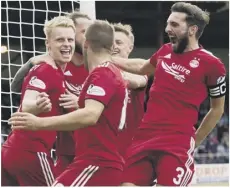  ??  ?? 0 Gary Mackay-steven, left, celebrates scoring his penalty