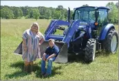  ??  ?? Katelynn Johnson, 16, and her brother, Kayden Johnson, 8, help on the family farm in Zion. Both attend school in the Izard County Consolidat­ed School District.