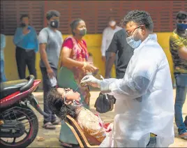  ??  ?? A health worker collects a swab sample for a Covid-19 test, in Mumbai on Wednesday.