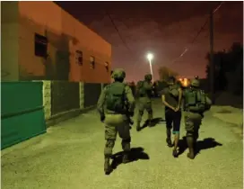  ?? (IDF Spokespers­on’s Unit) ?? IDF FORCES detain a Palestinia­n during their search for the Barkan terrorist.