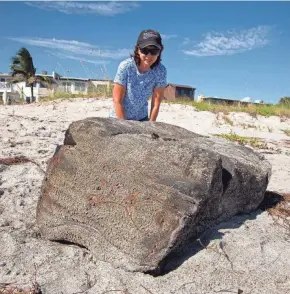  ?? MALCOLM DENEMARK/FLORIDA TODAY ?? Dr. Melanie Rotenberg of Indialanti­c was walking the beach with family members picking up trash when they came across a large, smelly mass about three feet by two feet and a-foot-and-a-half tall. The block smelled like rubber and petroleum. Experts in town for the Sea Bean Symposium pretty much determined it was rubber from a sunken WWII German ship.