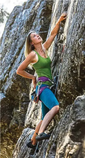  ??  ?? With 13-month-old daughter Rumi secure with a friend, Aae starts her climb up a route called Snake Fingers at Fun Rock in Mazama, Washington.