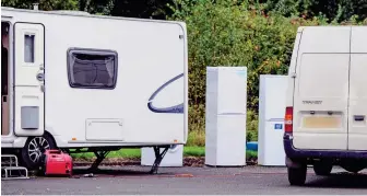  ??  ?? Unsightly: The group left washing machines and fridges outside their vans