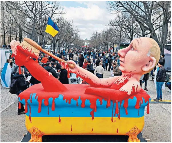  ?? ?? Protesters outside Russia’s Berlin embassy yesterday bring Vladimir Putin to book for Ukraine bloodbath