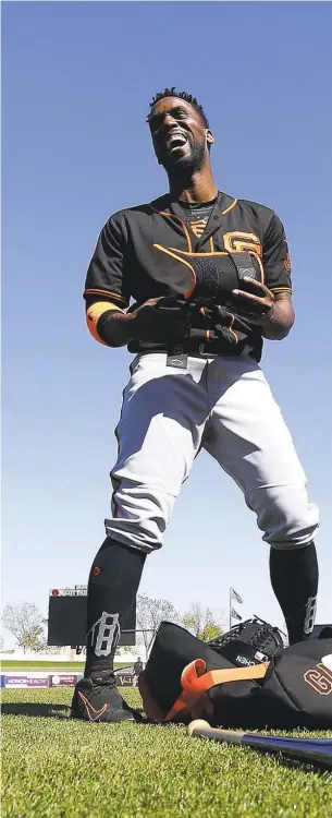  ??  ?? McCutchen, left, laughs with coach Hensley Meulens during a spring training workout in Scottsdale, Arizona. He spent much of the spring providing the kind of quiet leadership the Giants hoped for when they acquired him, tutoring rookie Steven Duggar,...