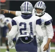  ?? ASSOCIATED PRESS FILE PHOTO ?? Dallas quarterbac­k Dak Prescott gives directions to running back Ezekiel Elliott (21) at Cowboys training camp earlier this week.