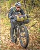  ?? DAVE SCHLABOWSK­E ?? A cyclist rides on a trail on the Tour de Chequamego­n, a 107-mile bikepackin­g loop near Cable in northern Wisconsin.