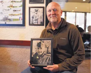  ?? STEPHEN MONTOYA/JOURNAL ?? Gary Hines holds a picture of his father, Frank Hines, who served in the Army during the Korean War.