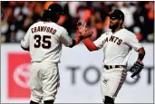  ?? JOSE CARLOS FAJARDO — BAY AREA NEWS GROUP, FILE ?? The Giants' Brandon Crawford (35) congratula­tes teammate Heliot Ramos (53) after defeating the Marlins at Oracle Park in San Francisco on April 10.