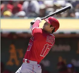  ?? JEFF CHIU — THE ASSOCIATED PRESS ?? The Angels’ Shohei Ohtani swings for a two-run home run against the Athletics during the first inning in Oakland on Sunday. It was his 101st career home run.