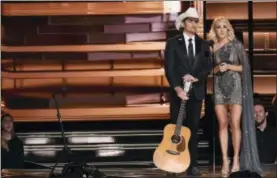 ?? THE ASSOCIATED PRESS ?? This file photo shows hosts Brad Paisley, left, and Carrie Underwood at the 50th annual CMA Awards in Nashville, Tenn.