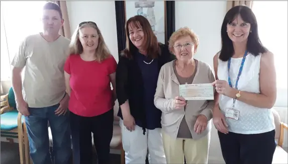  ??  ?? Olive Brady and family present the cheque to the Hospice Homecare