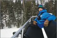  ?? ?? Mike Nathan, sustainabi­lity manager at Arapahoe Basin Ski Area, rides a lift Jan. 20.