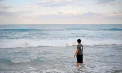  ?? Photos by Brent McDonald, © The New York Times Co. ?? Adelso at the beach in Boca Raton, Fla., where he lives with his aunt, in March. Adelso has not seen his father in more than three years.