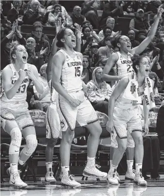  ?? THE ASSOCIATED PRESS ?? From left, Connecticu­t starters Katie Lou Samuelson, Gabby Williams, Kia Nurse and Azurá Stevens react on the sideline during Saturday’s game against Saint Franciis in Storrs, Conn. UConn won 140-52.