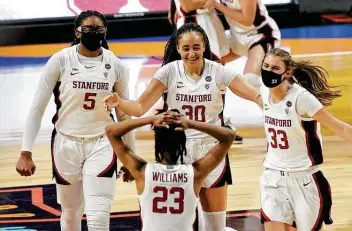  ?? Kin Man Hui / Staff photograph­er ?? Stanford's Francesca Belibi, left, Haley Jones and Hannah Jump run toward Kiana Williams to celebrate after defeating South Carolina in a Final Four semifinal on Friday at the Alamodome.