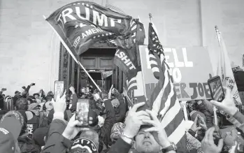  ?? JOHN MINCHILLO/AP ?? President Trump supporters take selfies, photos and videos last week at the Capitol in Washington.