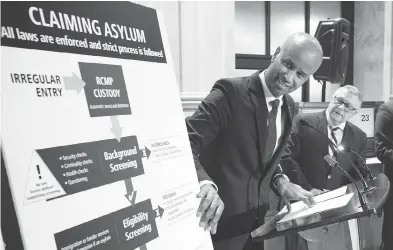  ?? PAUL CHIASSON / THE CANADIAN PRESS ?? Immigratio­n Minister Ahmed Hussen holds a press conference in Montreal Monday on the situation of irregular migration into Canada as Public Safety Minister Ralph Goodale looks on.