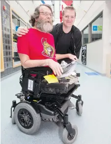  ?? WAYNE CUDDINGTON ?? John Woodhouse, 63, who received a motorized wheelchair to get around town thanks to a neighbourh­ood friend and JCC gym manager Ryan Armitage, right, got the attention of Senators staff, who arranged for tickets for the pair to see the team play on...