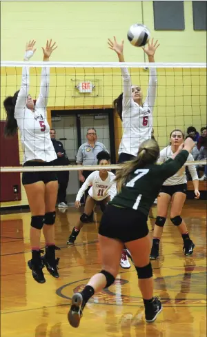  ?? Photo by Ernest A. Brown ?? Lincoln senior middle hitter Nicole Lezon (6) blocks a Chariho free ball during the No. 2 Lions’ sweep of the No. 3 Chargers in the Division II quarterfin­als Friday night at Lincoln Middle School.